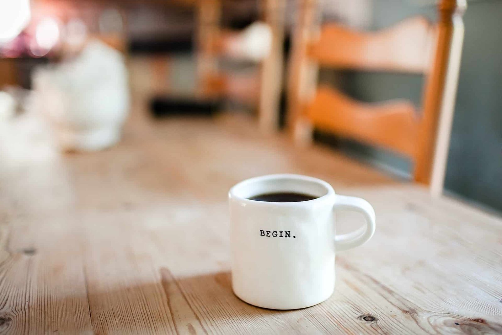 white cup of coffee on a wooden table